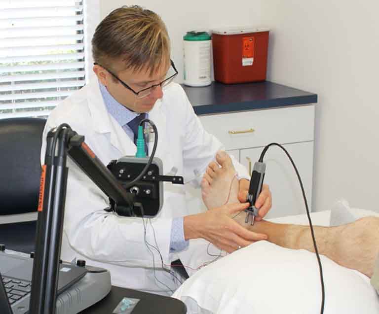 a doctor holding patient's left feet